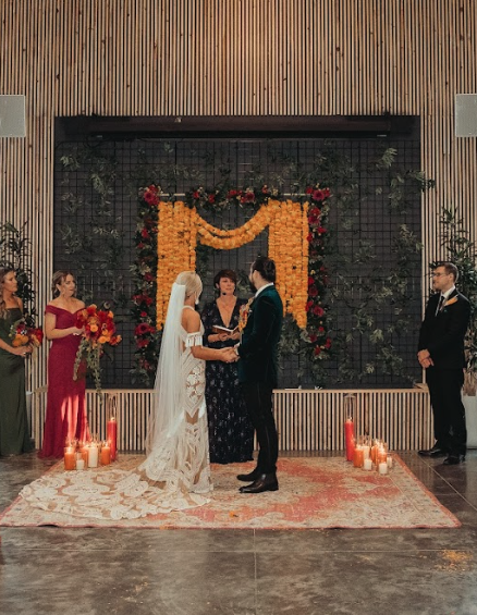 Officiant speaking to bride and groom during indoor wedding ceremony at Retreat 21 near Columbus, Ohio